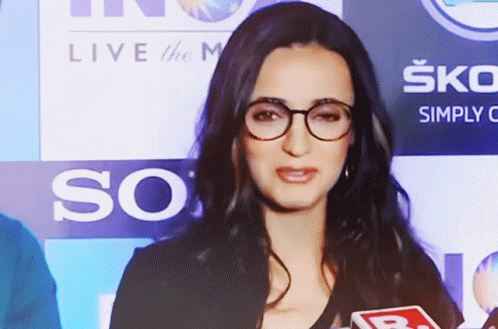 Woman With Glasses at Live the M Sign