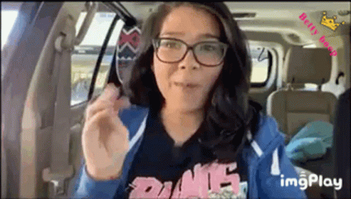 Woman With Glasses Eating Food in Back Seat