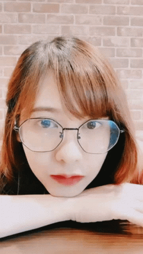 Woman With Glasses Hand on Chin
