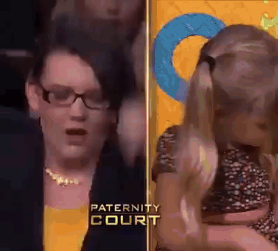 Woman With Glasses Holding Child At Paternity Court GIF