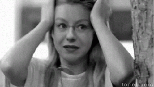 Woman With Glasses Holding Head