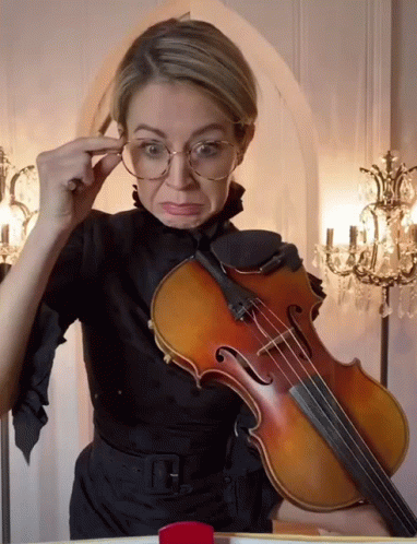 Woman With Glasses Holding Violin Making Face