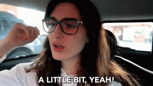 Woman With Glasses in Car Saying A Little Bit Yeah