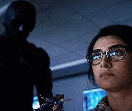 Woman With Glasses Looking in Dark Room With Man
