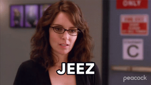Woman With Glasses Saying Jeez In Front Of Only C Sign GIF