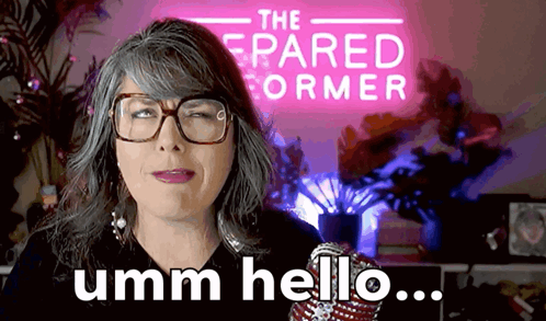 Woman With Glasses Says Umm Hello in Front of The Pared Former Sign