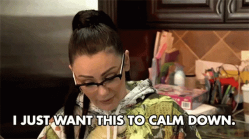 Woman With Glasses Sitting In Kitchen GIF