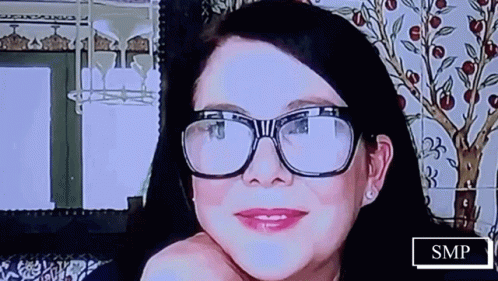 Woman With Glasses Smiling With SMP Sign GIF