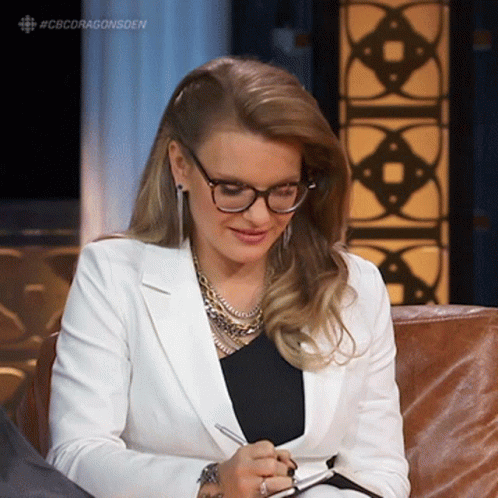 Woman with Glasses Writing in Notebook