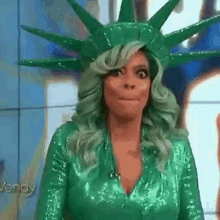 Woman With Green Hair And Green Costume, Statue Of Liberty Hat GIF