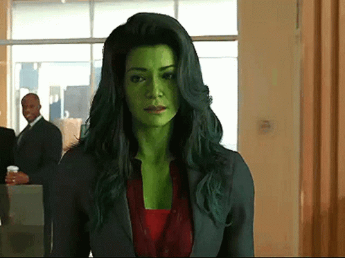 Woman with Green Hair and Green Face Standing in Hallway