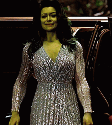 Woman With Green Hair and Silver Dress Standing Next to Car
