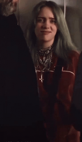 Woman With Green Hair In Red Jacket And Necklaces GIF