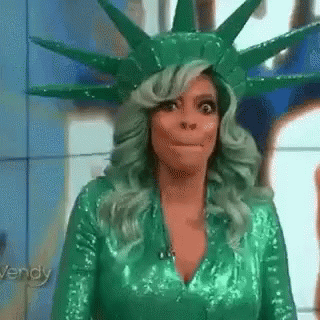 Woman with Green Hair in Statue of Liberty Costume Making Funny Face