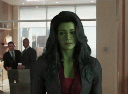 Woman With Green Hair Standing in Front of Two Men