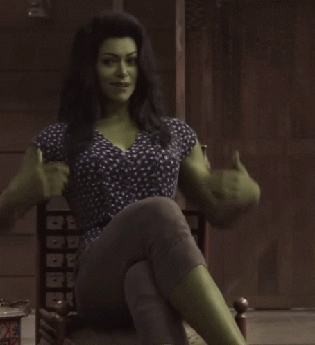 Woman With Green Muscles Sitting Cross-Legged