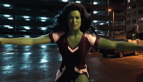 Woman With Green Muscles Standing In Parking Garage GIF
