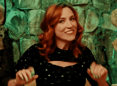 Woman With Green Nails And Red Hair Smiling GIF