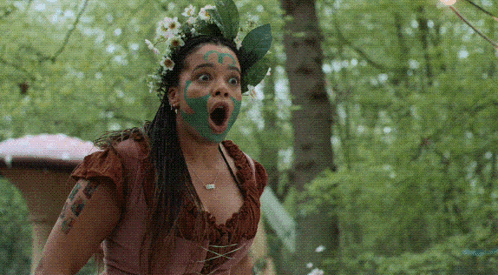 Woman With Green Paint on Face and Flower Crown