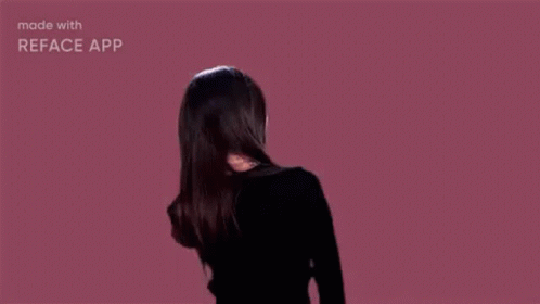 Woman With Hair Blowing in Wind on Pink Background