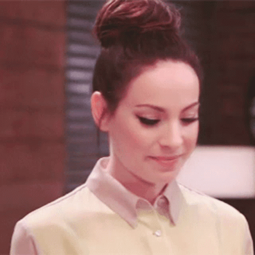 Woman With Hair In Bun Wearing Yellow Shirt GIF