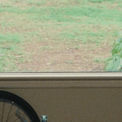 Woman With Hat And Long Hair Looking Out Window GIF