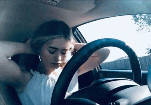 Woman with Head on Steering Wheel