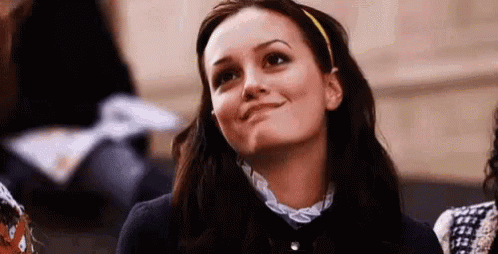 Woman with Headband Smiling Looking Up in Classroom