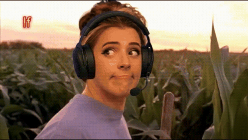 Woman With Headphones And Mic Making Face In Field GIF