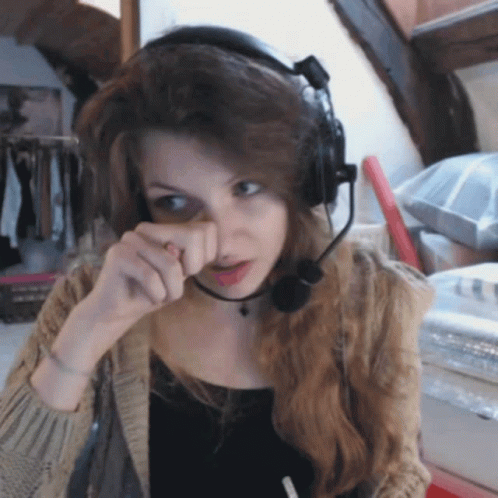 Woman With Headphones And Microphone Wiping Face