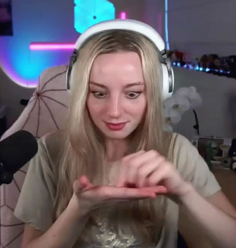 Woman With Headphones Holding Small Object