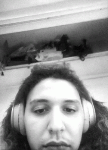 Woman With Headphones Looking at Camera