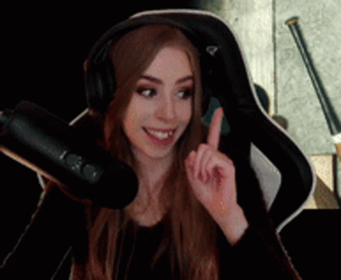 Woman with Headphones Pointing Upwards at Microphone