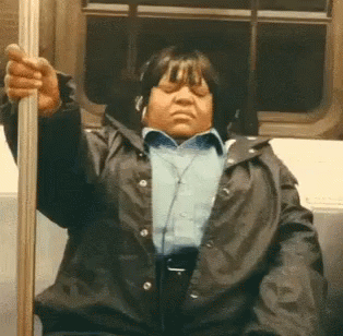 Woman with Headphones Sitting on Train