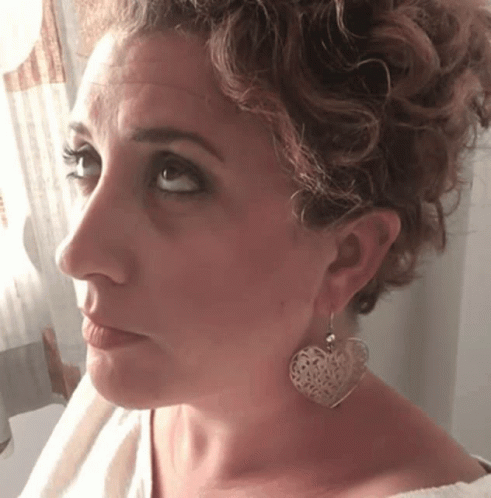 Woman With Heart-Shaped Earrings Looking at Camera