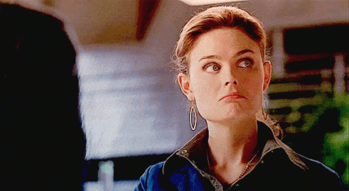 Woman With Hoop Earrings and Necklace Looking at Camera