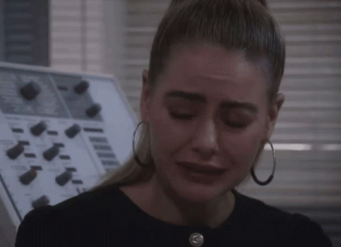 Woman With Hoop Earrings Crying in Front of Control Panel