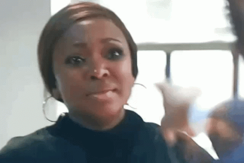 Woman With Hoop Earrings Making Funny Face By Window GIF