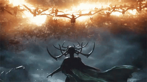 Woman With Horns Standing In Front Of Flock Of Birds Flying In Sky GIF