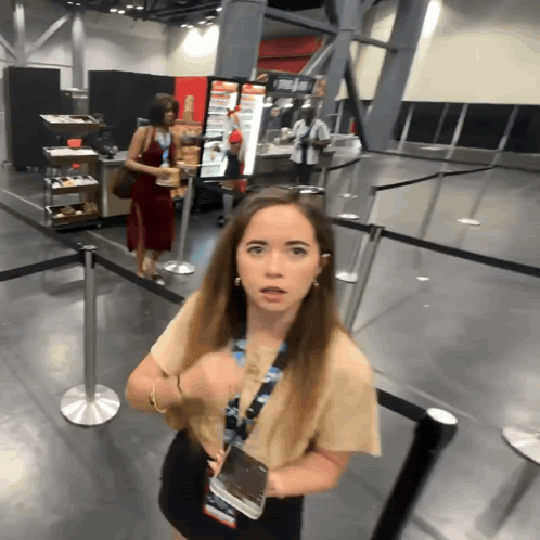 Woman With Lanyard in Front of Coca-Cola Machine