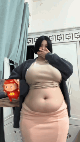 Woman With Large Belly in Front of Mirror