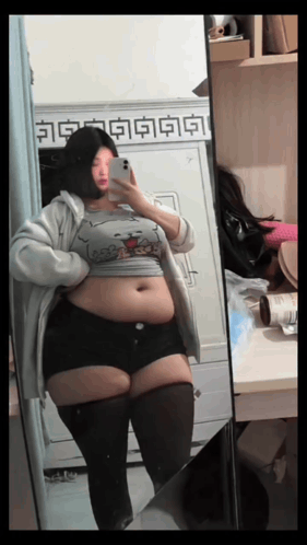 Woman With Large Belly in Front of Mirror
