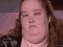 Woman With Large Belly Sitting On Couch GIF