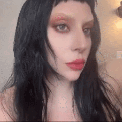 Woman With Long Black Hair And Red Lips Taking Selfie GIF