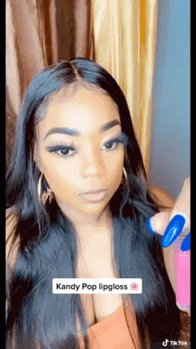 Woman With Long Black Hair Applying Kandy Pop Lipgloss