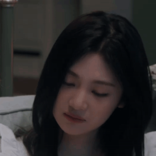Woman with Long Black Hair Eyes Closed on Bed