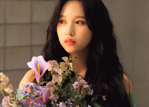 Woman With Long Black Hair Holding Flowers GIF
