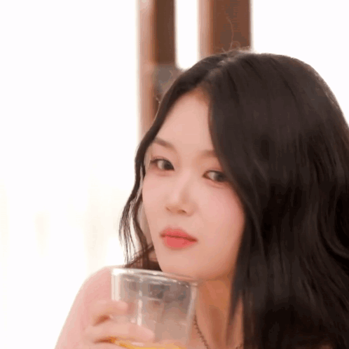Woman With Long Black Hair Holding Orange Juice GIF