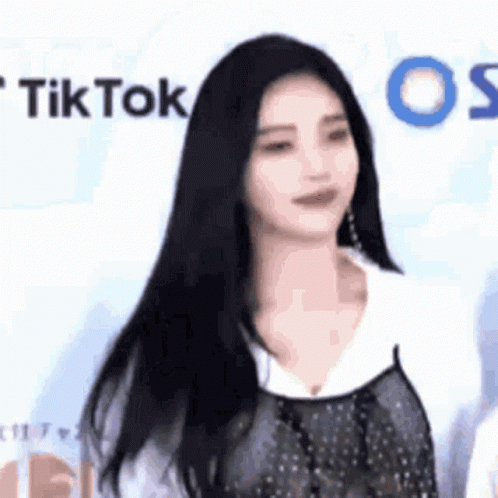 Woman With Long Black Hair in Front of TikTok Wall