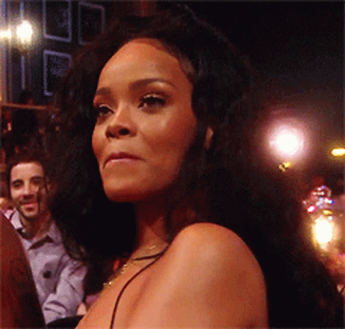 Woman With Long Black Hair Looks At Camera GIF